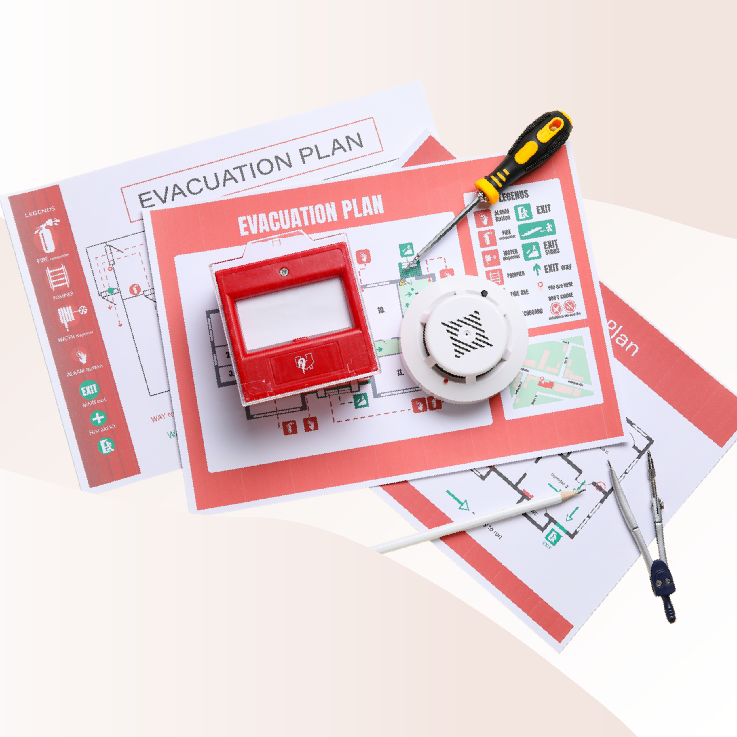 Fire evacuation plan and other fire safety documents piled under a smoke detector and alarm