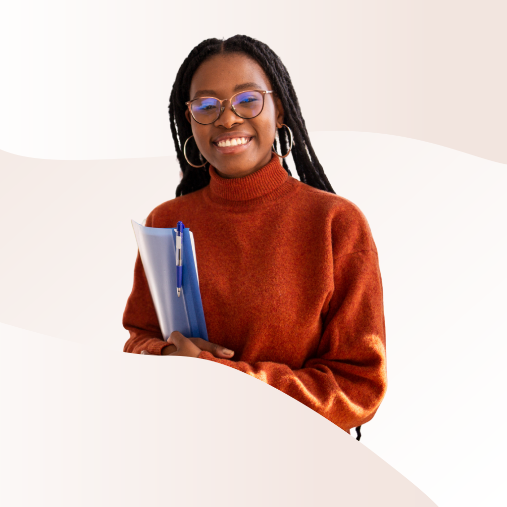 A young person carrying a folder and smiling at the camera.