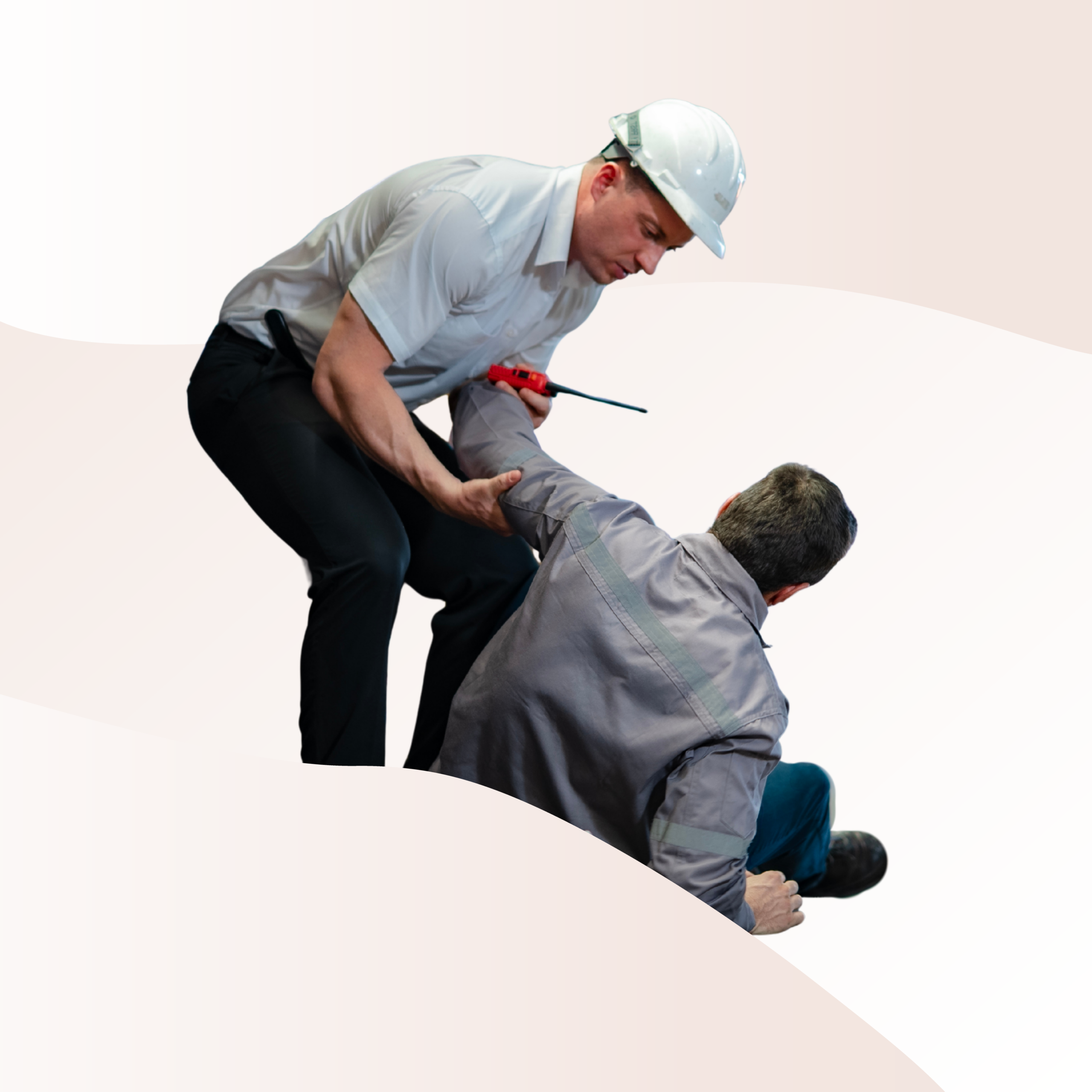 A worker who has fallen being helped by another worker
