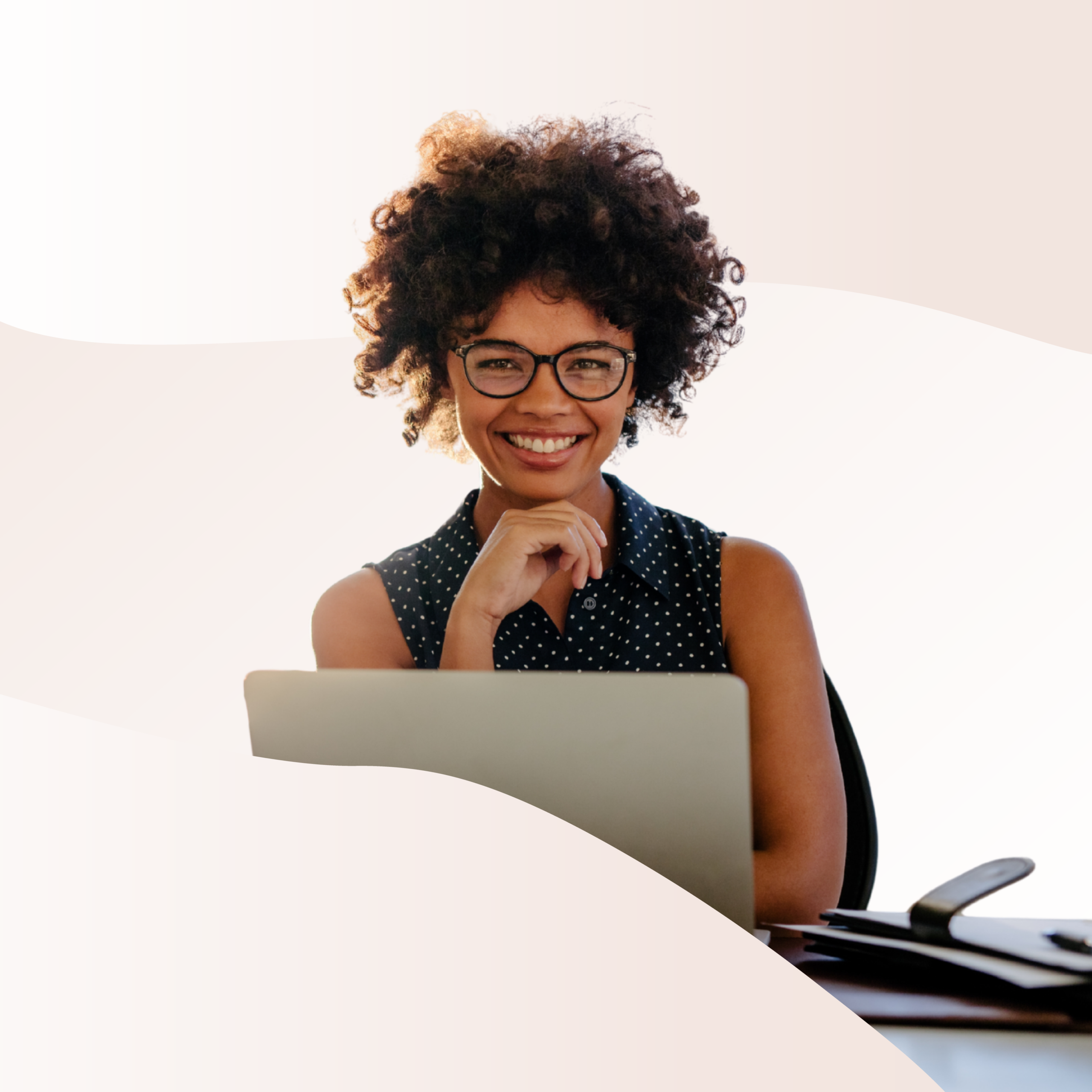 Someone smiling while working on a laptop